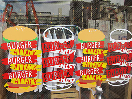 ガラス窓に描かれたカラフルで大きなハンバーガーのイラストが目印。